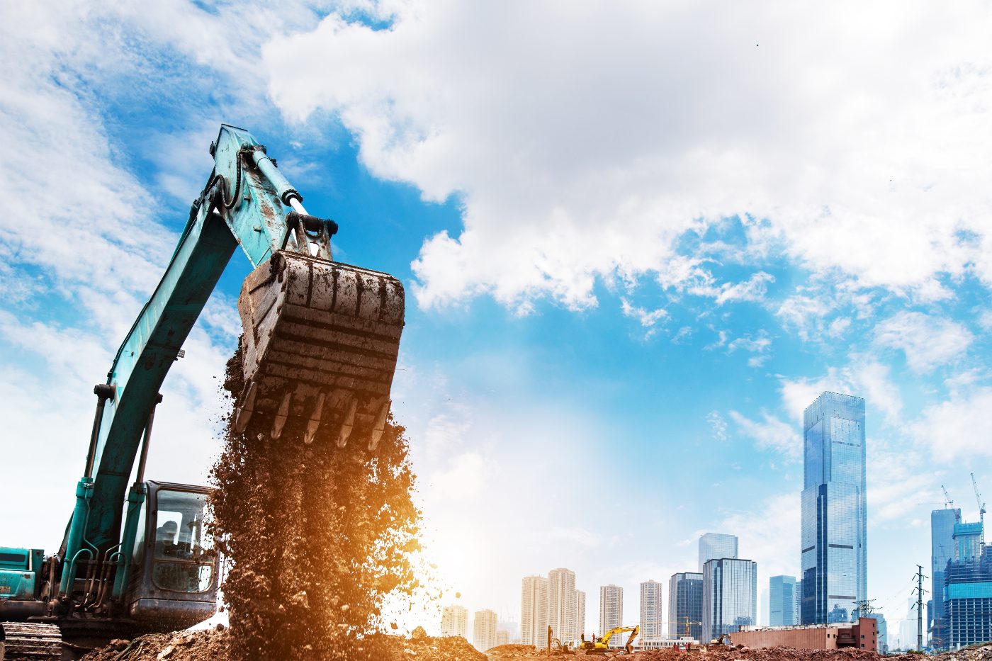 Excavator carrying out earthworks and site clearance for a construction project