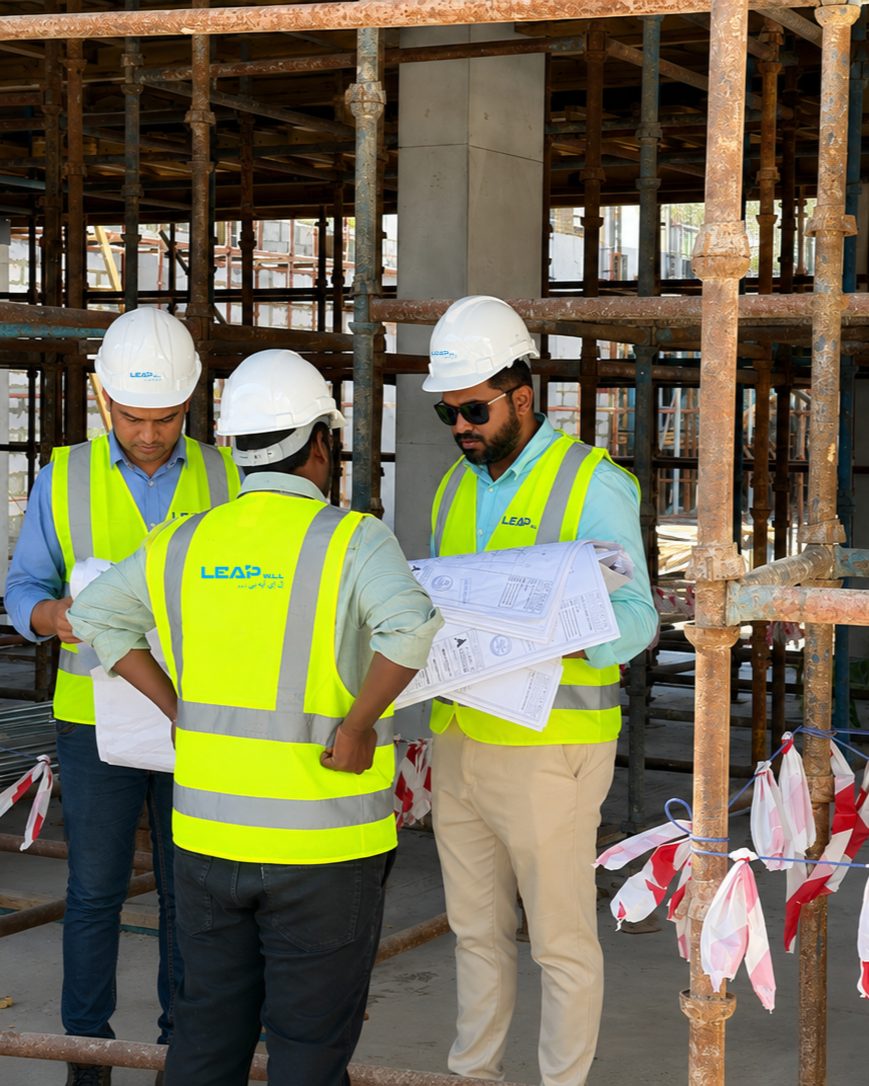 LEAP W.L.L engineers reviewing construction drawings on a reinforced concrete frame site in Bahrain